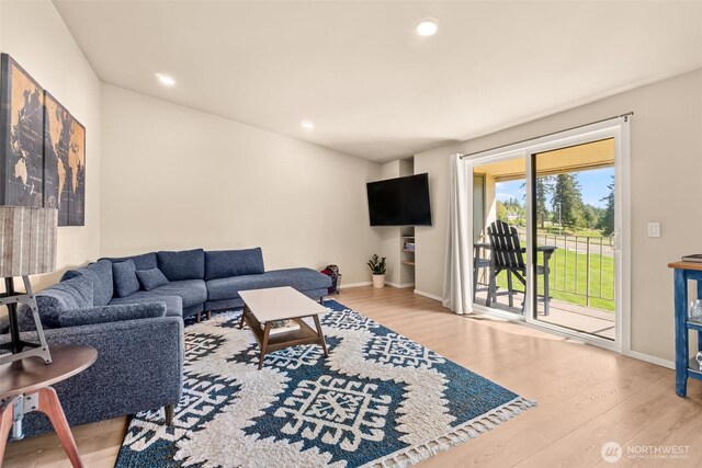 living area with wood finished floors, baseboards, and recessed lighting