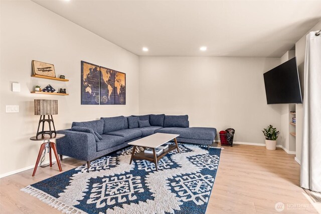 living area with wood finished floors, baseboards, and recessed lighting