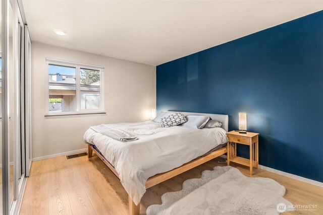 bedroom with baseboards and light wood-type flooring