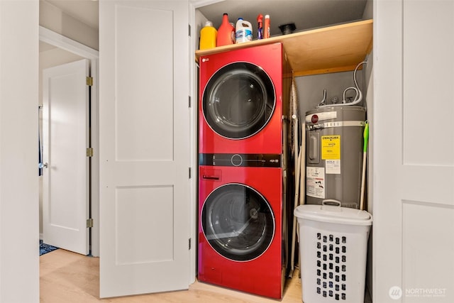 washroom featuring stacked washer / drying machine, water heater, and wood finished floors
