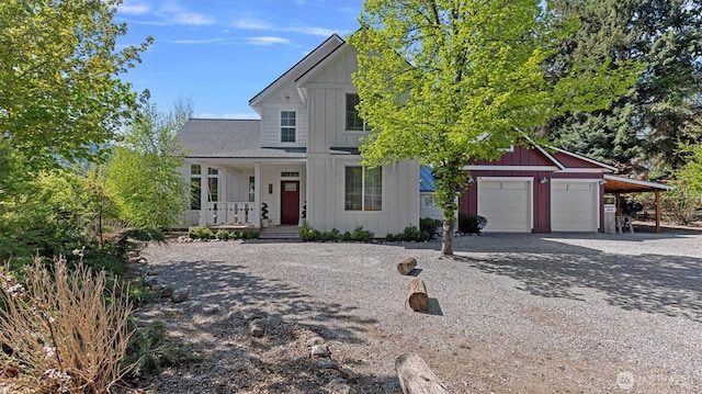 modern farmhouse with board and batten siding, a porch, driveway, and a garage