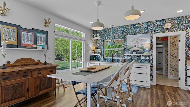dining room with wallpapered walls, dark wood-type flooring, baseboards, and recessed lighting