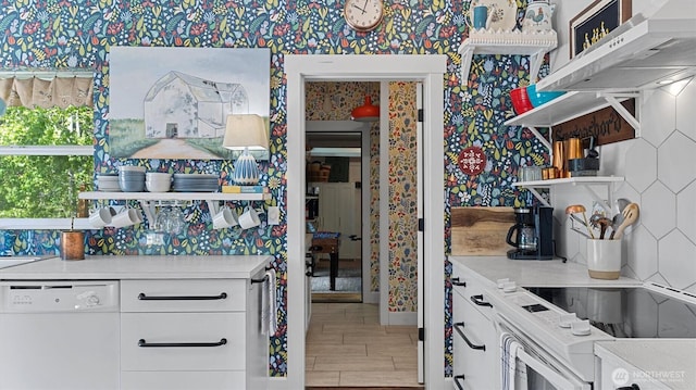 kitchen featuring white appliances, open shelves, under cabinet range hood, wallpapered walls, and wood finished floors