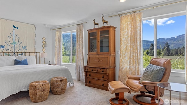 bedroom with a mountain view and light carpet