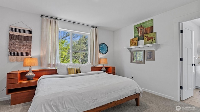 bedroom featuring baseboards and carpet flooring