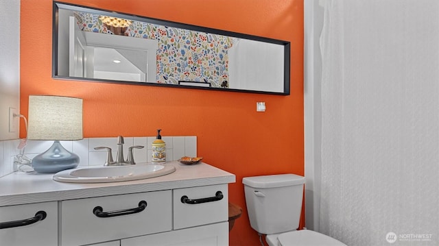 bathroom featuring toilet and vanity