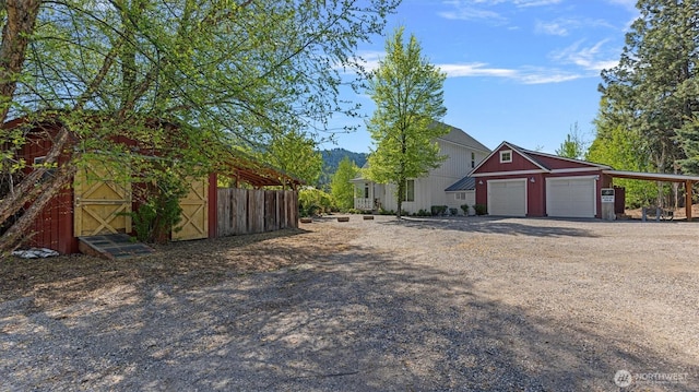 view of front of property featuring an outbuilding, driveway, and a mountain view
