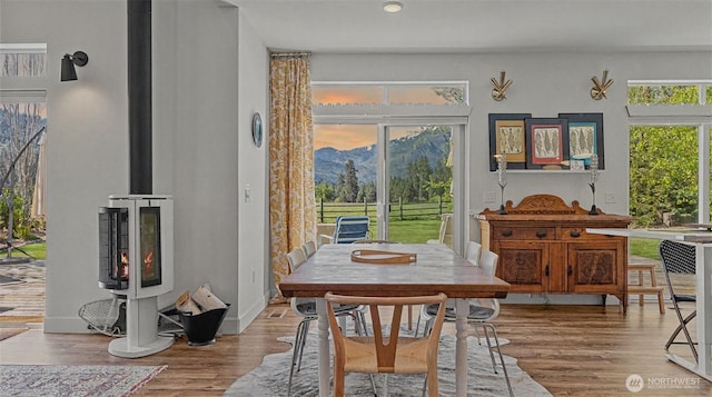 175 Joyful Pl, Leavenworth, WA 98826 - dining area with wood finished floors, a wood stove, and a mountain view