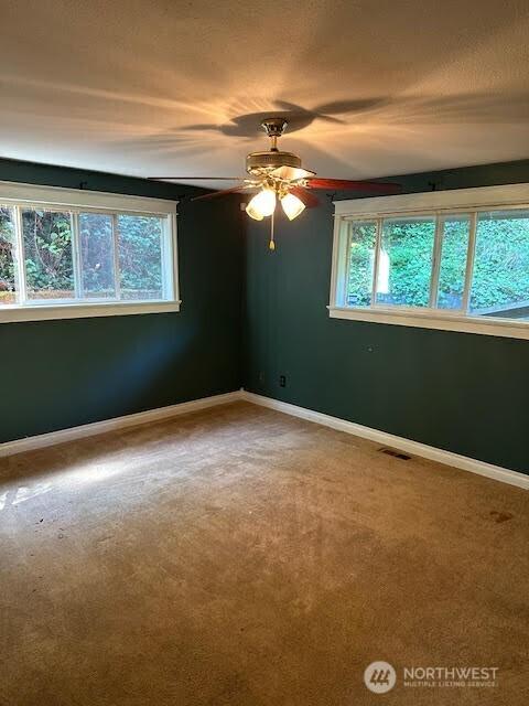 816 Sunrise Ln, Centralia, WA 98531 - empty room with carpet floors, ceiling fan, and baseboards
