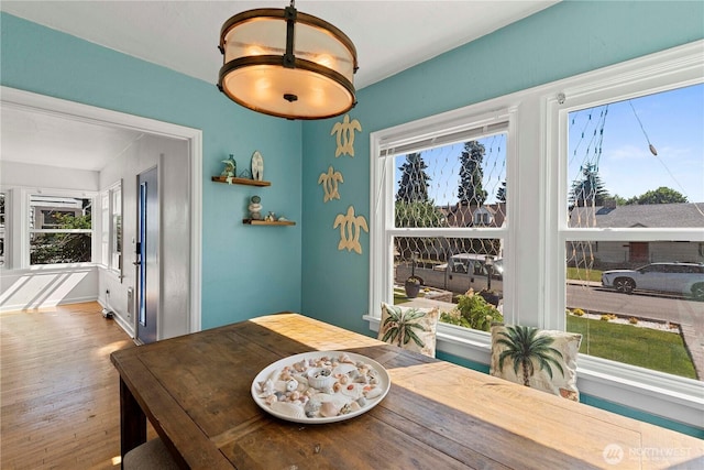 dining area featuring plenty of natural light and wood finished floors