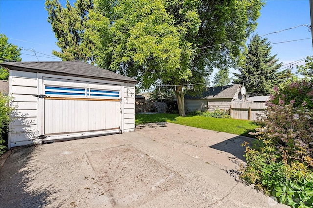 detached garage featuring a shed