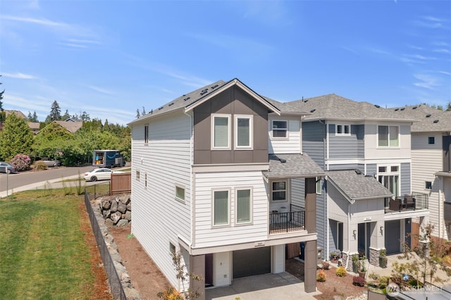 207 207th St SE Unit Eh49, Bothell, WA 98012 - rear view of property with roof with shingles, board and batten siding, an attached garage, and a balcony