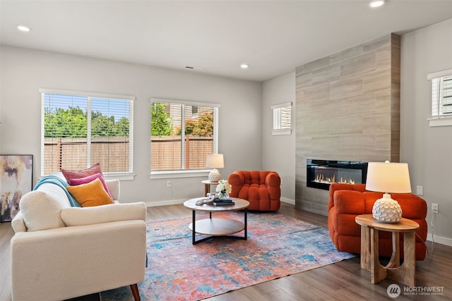 207 207th St SE Unit Eh49, Bothell, WA 98012 - living area featuring baseboards, wood finished floors, recessed lighting, and a tile fireplace