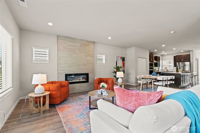 207 207th St SE Unit Eh49, Bothell, WA 98012 - living area with light wood finished floors, a tile fireplace, baseboards, and recessed lighting