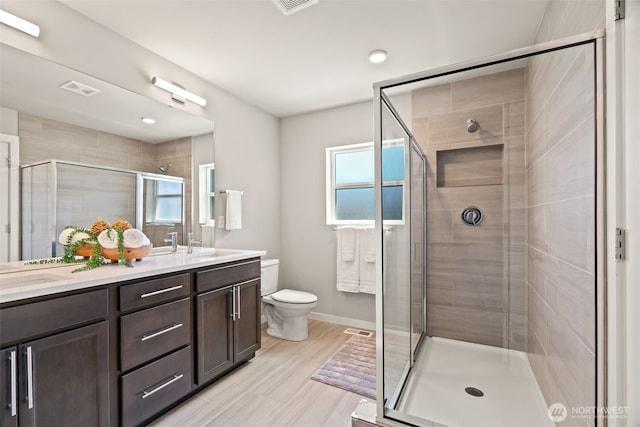 207 207th St SE Unit Eh49, Bothell, WA 98012 - full bathroom featuring double vanity, a stall shower, toilet, baseboards, and recessed lighting
