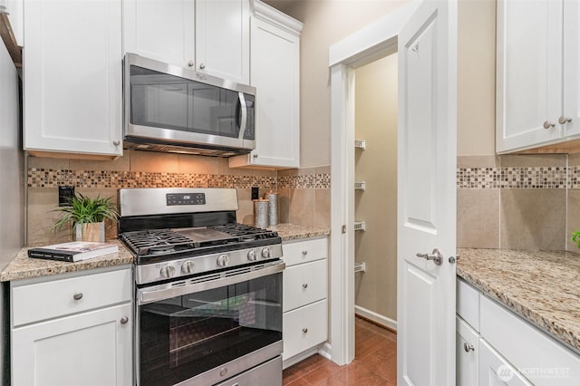 3723 218th Pl SE, Bothell, WA 98021 - kitchen featuring appliances with stainless steel finishes, backsplash, white cabinets, and light stone countertops