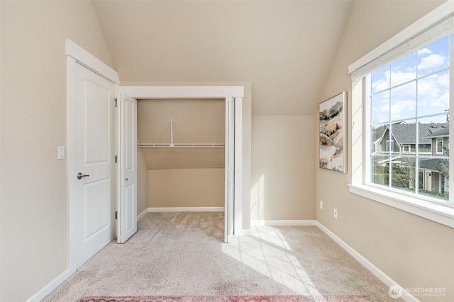 3723 218th Pl SE, Bothell, WA 98021 - unfurnished bedroom with lofted ceiling, carpet floors, a closet, baseboards, and a walk in closet