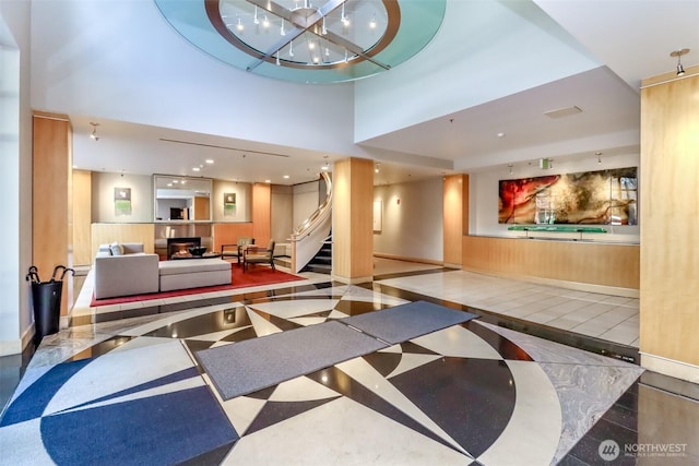 common area featuring stairway and a high ceiling