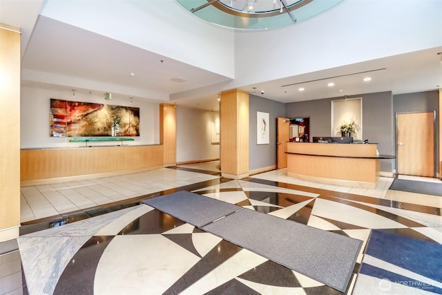 reception with a wainscoted wall and recessed lighting