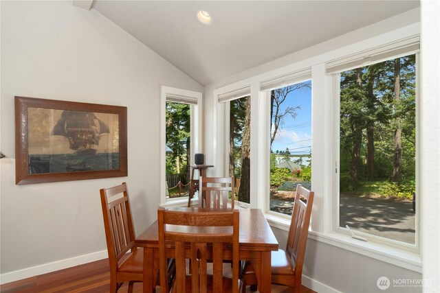 dining space with wood finished floors, baseboards, lofted ceiling, and recessed lighting