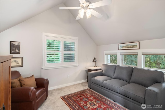 living area featuring carpet floors, vaulted ceiling, baseboards, and a ceiling fan