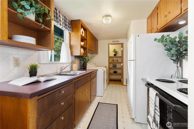 kitchen with white electric stove, a sink, open shelves, independent washer and dryer, and light floors