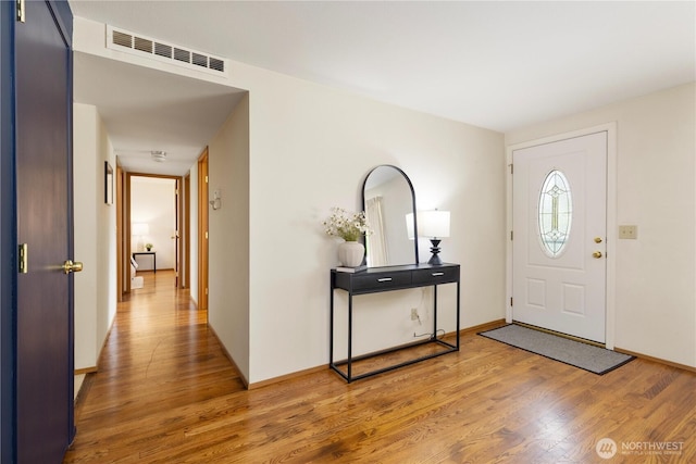 entryway featuring wood finished floors and baseboards