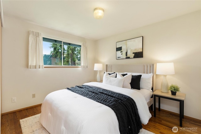 bedroom with wood finished floors and baseboards