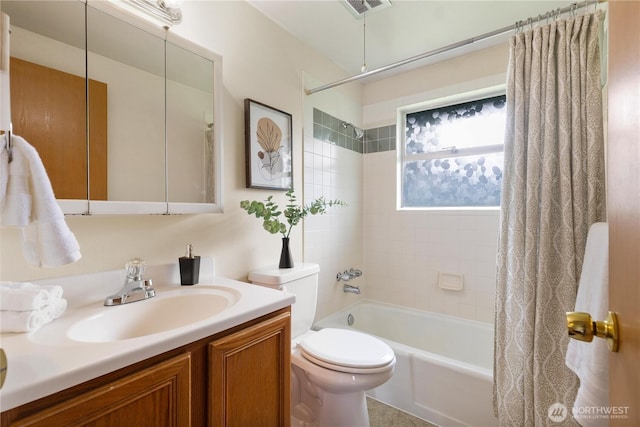 bathroom with toilet, shower / bath combination with curtain, and vanity