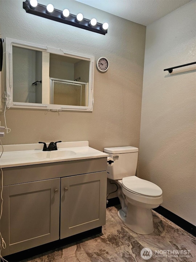 2100 S 336th St Unit P3, Federal Way, WA 98003 - bathroom featuring vanity, a shower stall, toilet, a textured wall, and baseboards