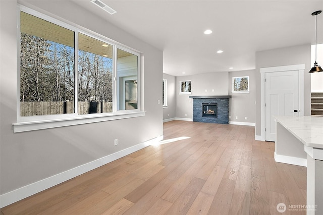 15709LOT12 SE 257th St, Covington, WA 98042 - unfurnished living room featuring baseboards, light wood-style floors, recessed lighting, stairway, and a fireplace