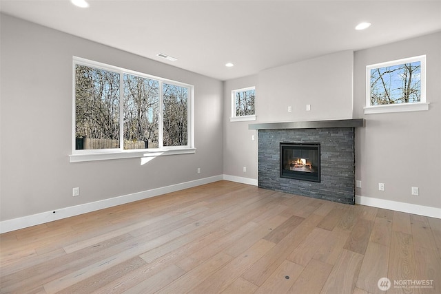 15709LOT12 SE 257th St, Covington, WA 98042 - unfurnished living room with wood finished floors, a stone fireplace, recessed lighting, and baseboards