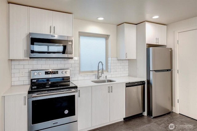 3325 Martin Luther King Jr Way S, Seattle, WA 98144 - kitchen featuring stainless steel appliances, a sink, light countertops, decorative backsplash, and recessed lighting
