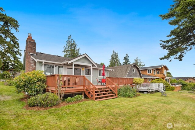 2967 Saratoga Rd, Langley, WA 98260 - back of property featuring a chimney, a sunroom, a lawn, and a wooden deck