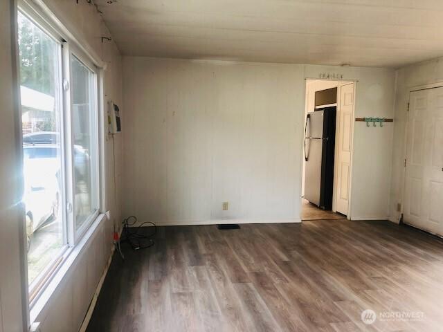 unfurnished room with plenty of natural light and wood finished floors