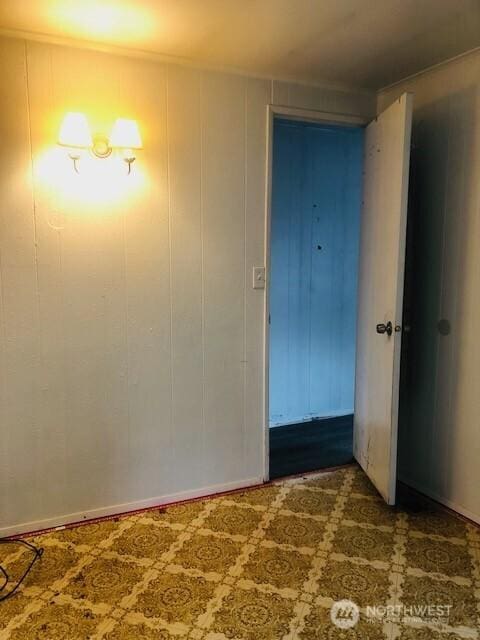 unfurnished room with baseboards