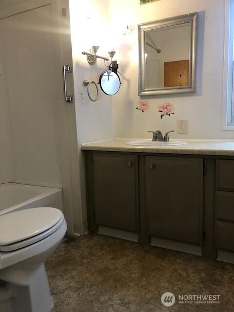 bathroom featuring vanity, toilet, a shower, and a bath