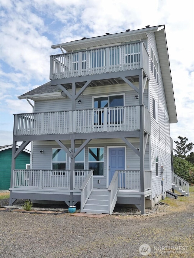 view of front of house featuring a balcony