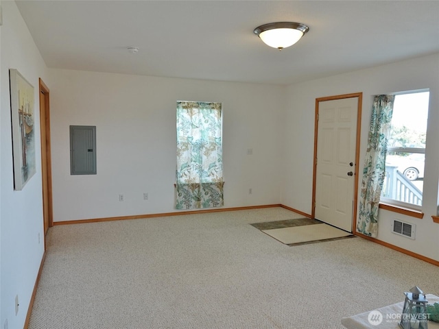 carpeted spare room with electric panel, baseboards, and a smoke detector