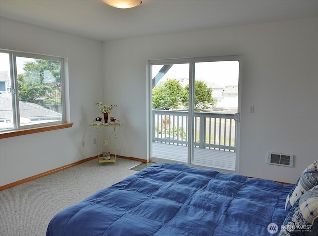 carpeted bedroom featuring access to exterior and baseboards