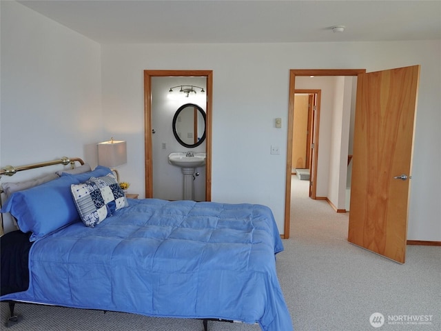 bedroom featuring carpet, connected bathroom, and baseboards