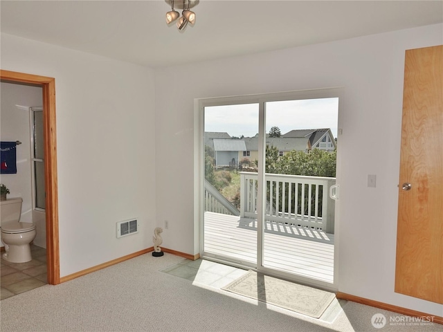 unfurnished room with carpet flooring and baseboards