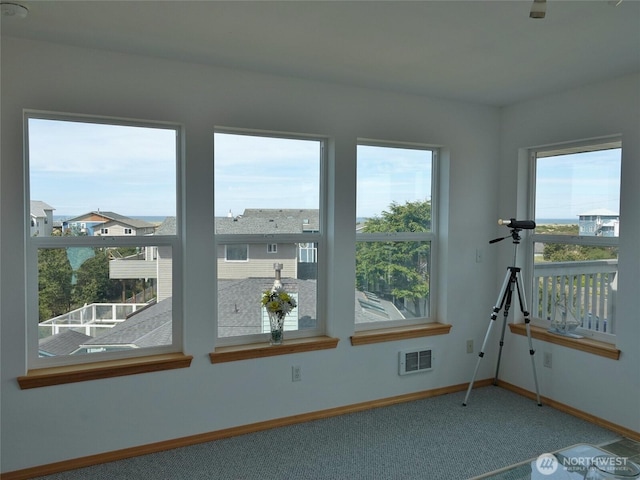 unfurnished room featuring carpet flooring and baseboards