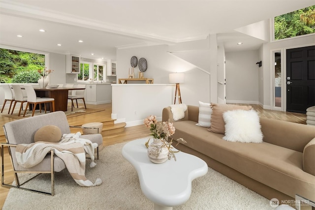 living room featuring recessed lighting, light wood-type flooring, and baseboards