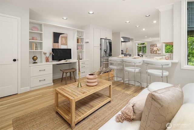 living area featuring light wood finished floors and recessed lighting