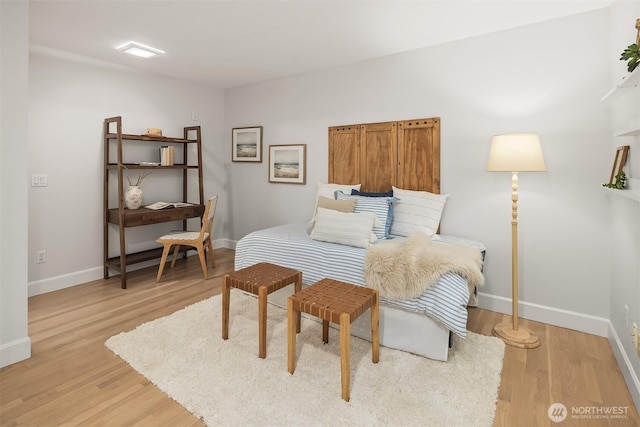 bedroom featuring baseboards and light wood finished floors
