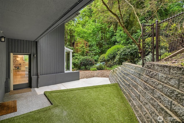 view of green lawn featuring a patio