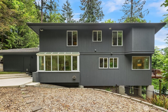 back of property featuring fence and entry steps