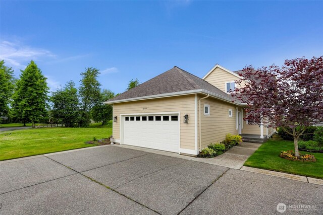 549 E Maberry Dr, Lynden, WA 98264 - view of side of home featuring driveway, a yard, roof with shingles, and a garage