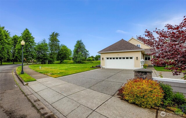 549 E Maberry Dr, Lynden, WA 98264 - view of side of home featuring a garage, driveway, and a lawn
